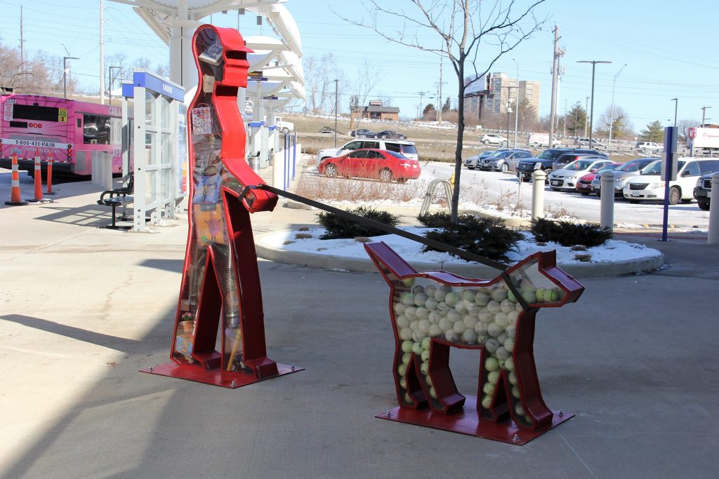 Art work showing person walking dog.