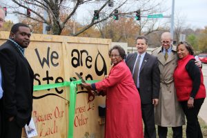 Pagedale Mayor Mary Carter prepares to cut the ribbon on the new art installation.