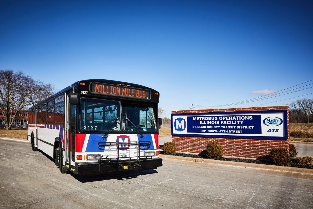 million bus in front of sign