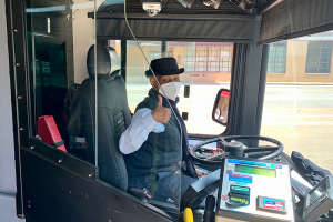 Operator giving a thumbs up behind a polycarbonate operator shield