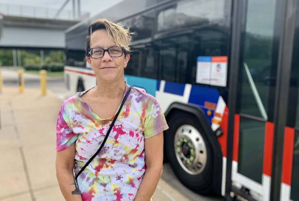 Image of passenger Lisa in front of a MetroBus