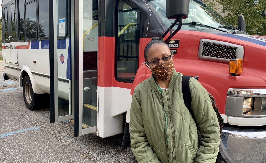 Passenger Profile: Roshonda standing in front of a Metro Call‑A‑Ride van