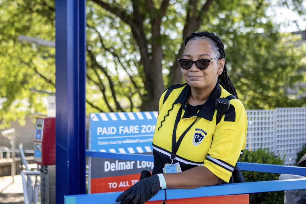 LaAndrea, fare enforcement team member, standing at the entrance to the Delmar Loop MetroLink Station smiling