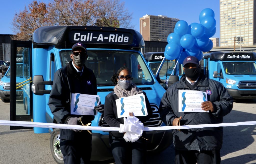 2020 Call-A-Ride Operators of the year standing in front of the new Call-A-Ride vans, holding their certificates. From left to right: Jerome, Barbara, Howell