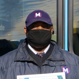 Metro Call‑A‑Ride 2020 Operator of the Year Howell, smiling at the camera and holding his certificate of achievement
