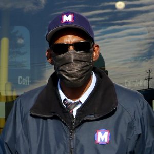 Metro Call-A-Ride 2020 Operator of the Year Jerome, smiling at the camera and holding his certificate of achievement