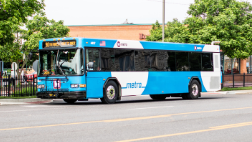 A MetroBus pulls up to a bus stop in front of the Clayton Rd. Schnucks.