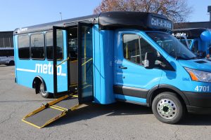 A Call-A-Ride van parked with its passenger doors open and ramp extended.