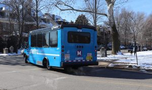 A Call-A-Ride van makes a right-hand turn at an intersection in a residential area.