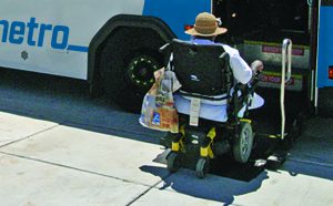 MetroBus passenger in a wheelchair boarding at the front of the bus