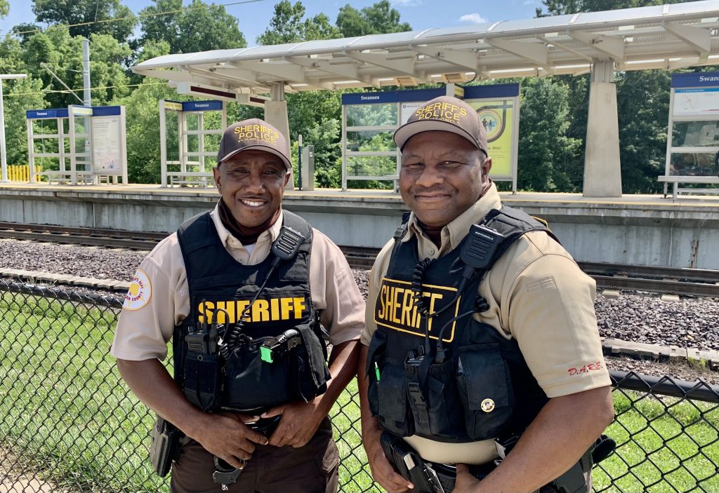 Deputies Romero and Chris Davis standing in front of the Swansea MetroLink Station