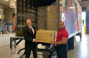 Taulby Roach (left) and James Clark (right) with donated masks from the Urban League of Metropolitan St. Louis