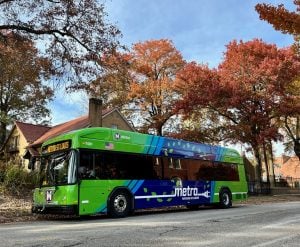 40-foot electric bus on the streets of St. Louis with trees showing fall leaves