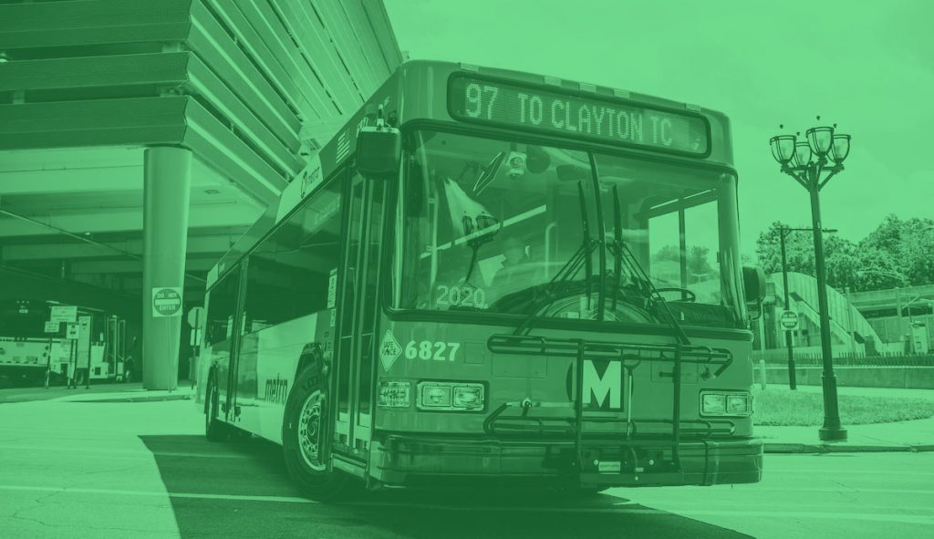 A MetroBus pulls out of the Clayton transit center. The operator can be seen through the windshield.