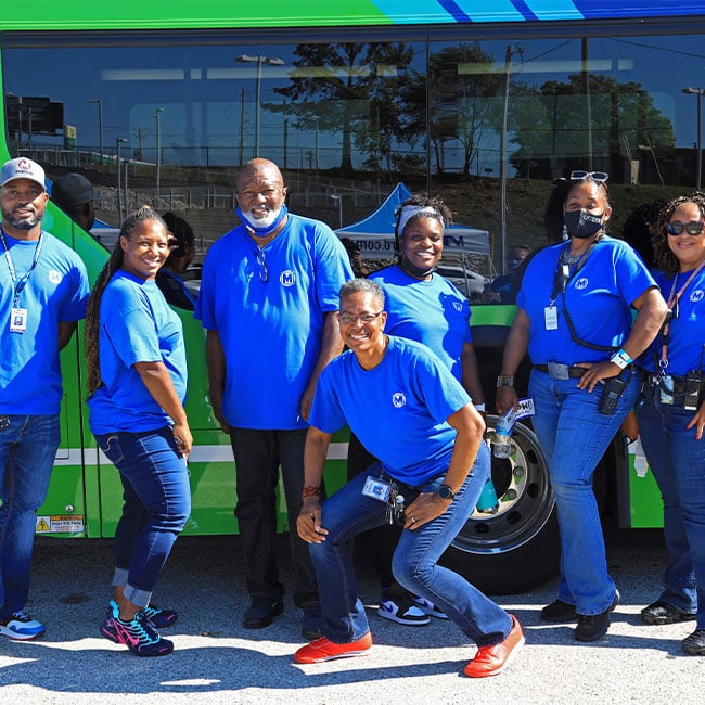 MetroFest team posing in front of Metro bus.