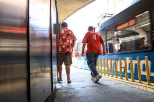 Two Cardinals fans walking on the Stadium Station platform