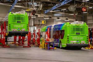 An electric MetroBus being repaired in a garage