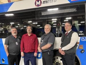 Metro Transit Quality Assurance team posing in front of a MetroBus.