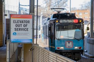 A MetroLink train approaches a platform where a sign says "Elevator out of service"