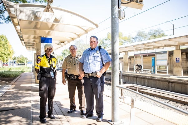 Photo of a Metro Transit security guard with two officers from St. Louis County Police and City of St. Louis Police