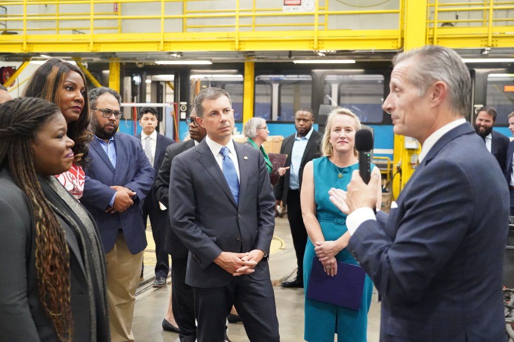 BSD President & CEO Taulby Roach giving a tour of the Illinois MetroLink Facility to U.S. Representative Bush, Mayor Tishaura Jones, Mayor Charles Powell III, U.S. Secretary of Transportation Pete Buttigieg, U.S. Representative Budzinski, and others