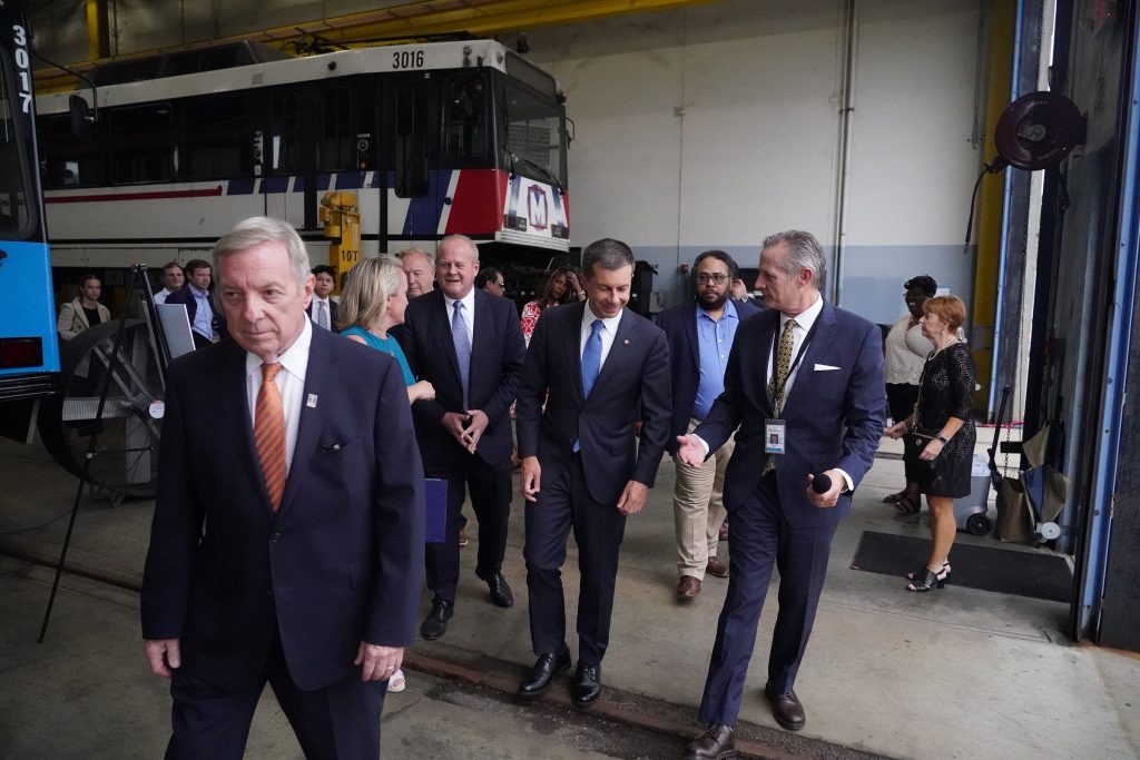 Photo of U.S. Senator Durbin, U.S. Representative Budzinski, St. Clair County Chairman Mark Kern, U.S. Secretary of Transportation Pete Buttigieg, BSD President & CEO Taulby Roach and others on a tour of the Illinois MetroLink facility