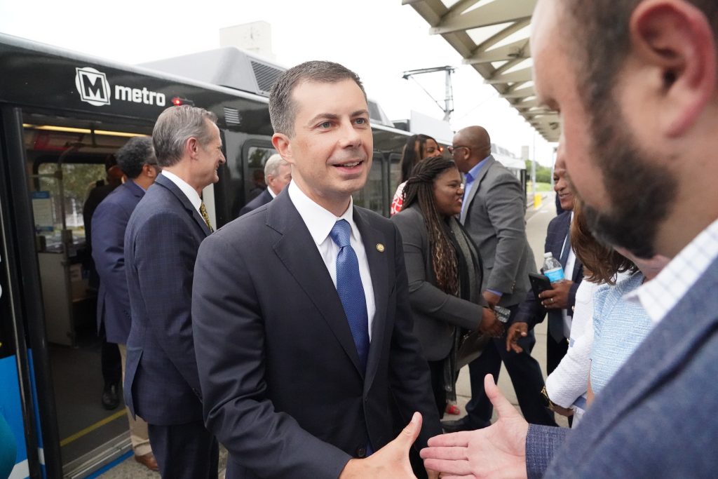 Photo of US Secretary of Transportation, Pete Buttigieg, on a MetroLink platform shaking hands