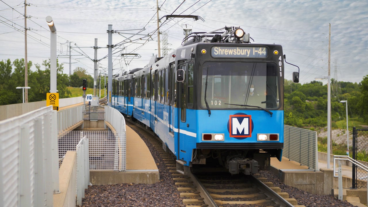 Blue MetroLink train approaching a station platform