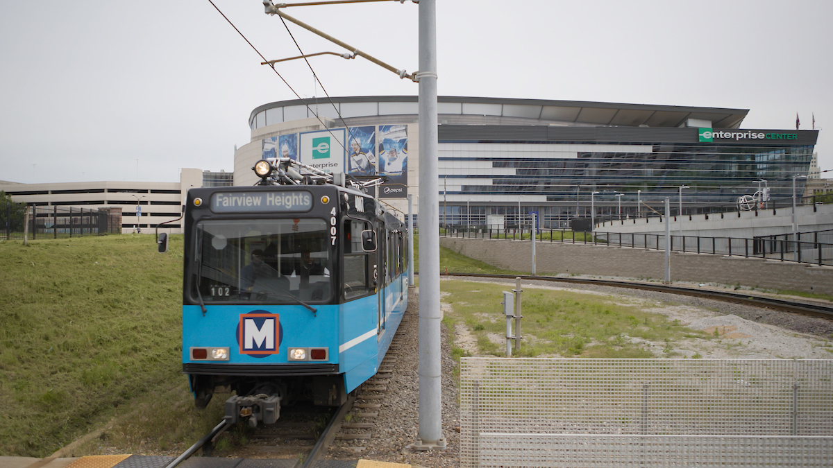 MetroLink train at the Civic Center Station with Enterprise Center in the background
