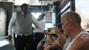 COO Ron Forrest talking to passengers on a bus