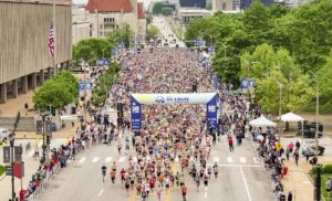 Photo of runners lined up at the starting line for the Greater St Louis Marathon on Market Street in front of Union Station